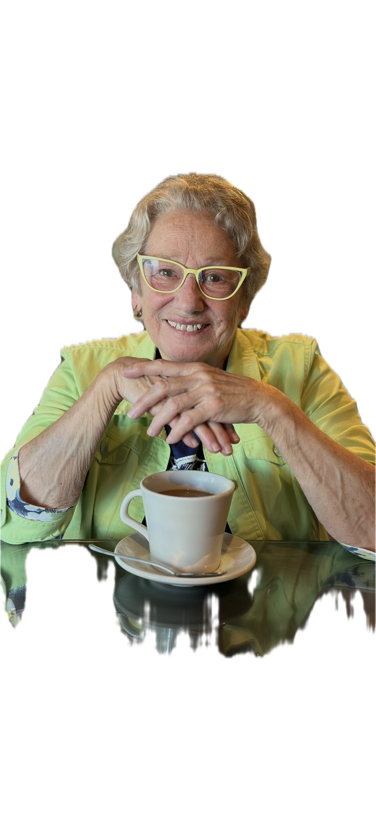 Buzziebeeteacher smiling at a table with a cup of tea